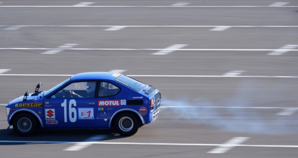 A purple Suzuki Whizzkid leaving a trail of smoke.